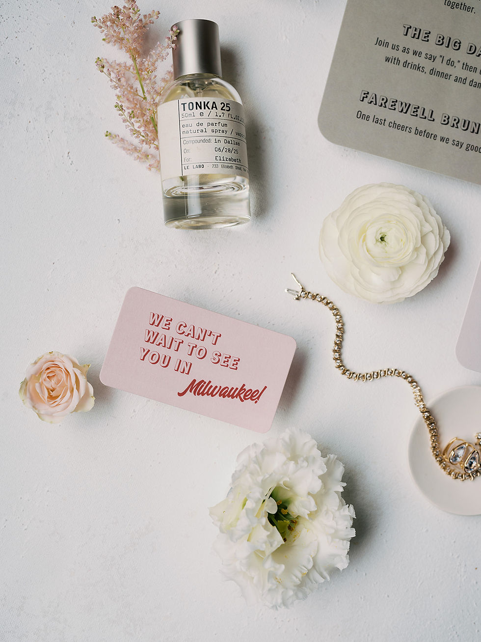 Flat lay of Designer wedding invitations with a small detail card see you in Milwaukee from a weddin
