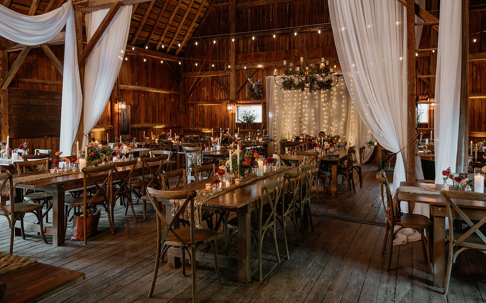 Wedding reception tables with florals at Abloom Farm in Saukville Wisconsin featuring a styled tablescape design