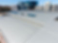Commercial building roof with city buildings