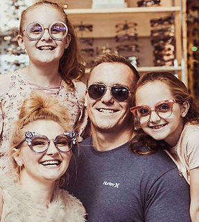 a family posing for a picture wearing their eye glasses
