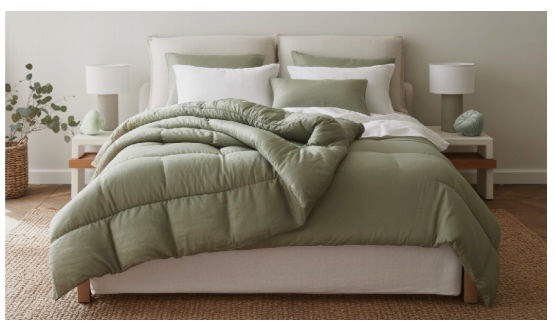 The image depicts a serene and luxurious bedroom featuring a beautifully made bed with sustainable eucalyptus sheets, organic percale cotton and French linen sheets, and matching duvet covers and pillowcases.