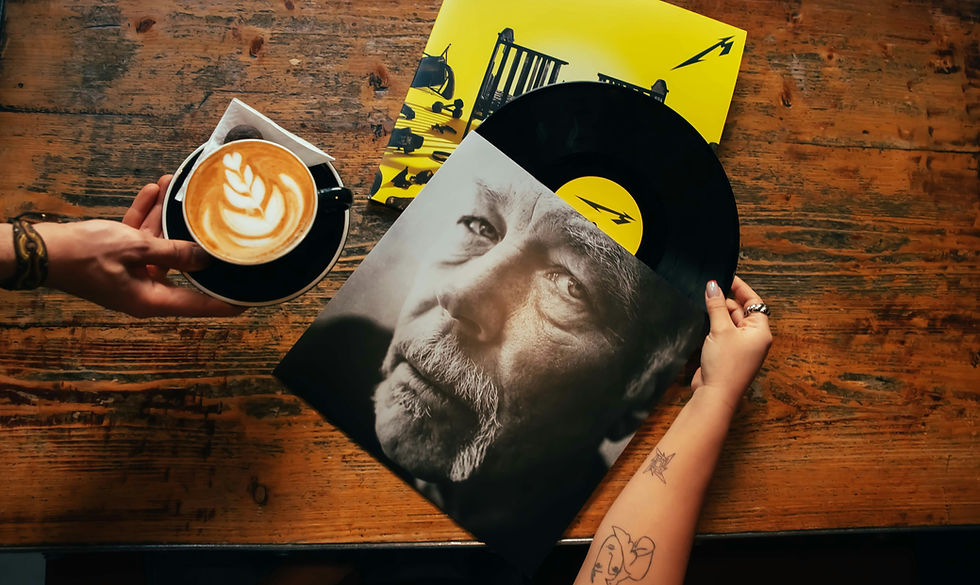 A quiet still life of a vinyl record and a cup of coffee on a table