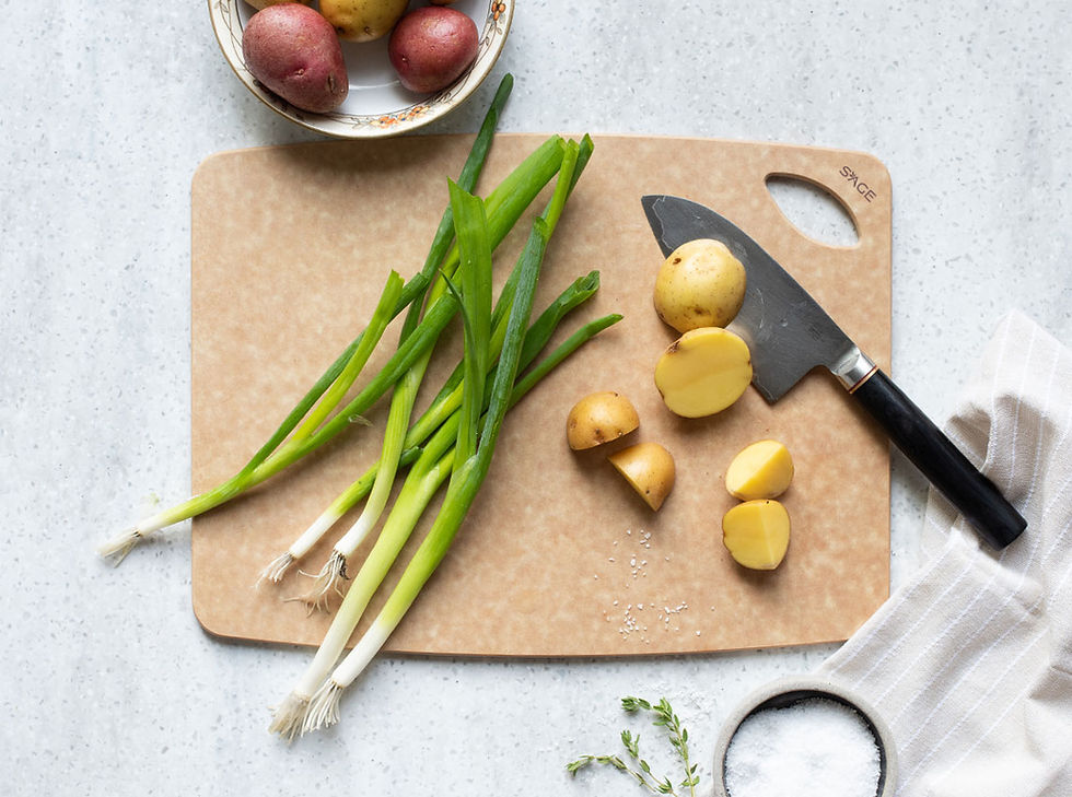 Chopped potatoes and scallions on Sage cutting board