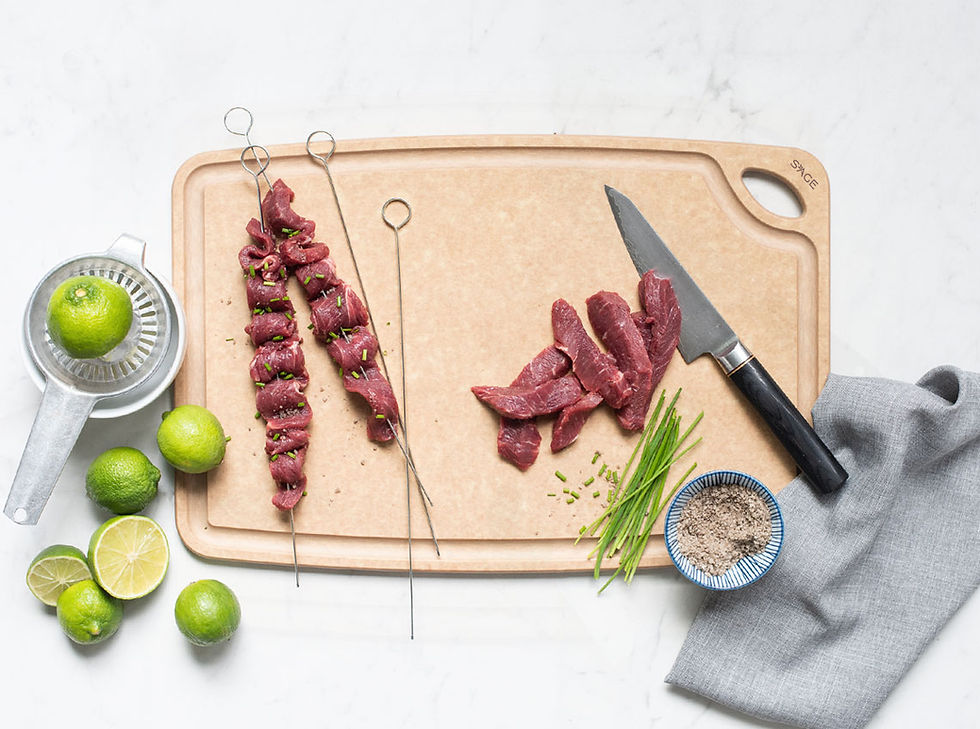 Raw meat skewers on Sage carving board