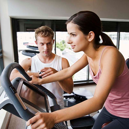 Trainer training a client on machine