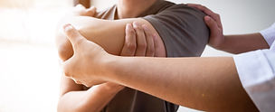 Therapist treating a male injured by rotator cuff stretching method, Physical therapy conc