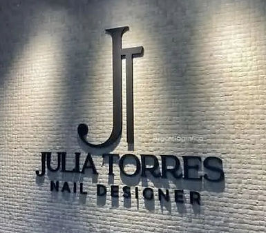 Custom professional 3D commercial logo and lettering mounted on a textured white wall with elegant spotlighting for interior branding.