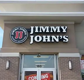 Illuminated "JIMMY JOHN'S" epoxy resin letters with a smooth, glossy finish on a storefront.
