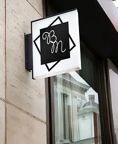 Square illuminated blade sign with BM logo