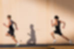 Two runners separated by a shadow