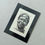 Thumbnail: Sir Bobby Charlton portrait linocut print in black mount