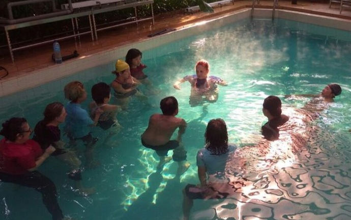 Watsu I training class in the pool showing students watching teacher Anat