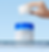 Hand holding wet white pad above Medicube Zero Pore Pad jar, with water dripping on a light blue background.