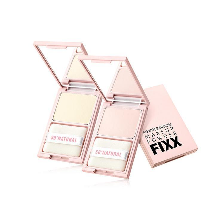 Two pink makeup compacts are open, displaying beige powder and applicators labeled "SO NATURAL." Packaging reads "POWDERROOM MAKEUP POWDER FIXX."