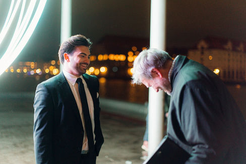 Bride and groom smiling and enjoying their wedding ceremony under the lights during the Light Festival in Copenhagen.