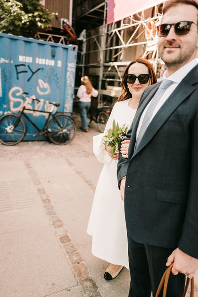 Bride and groom sharing a moment while passing road in Copenhagen.