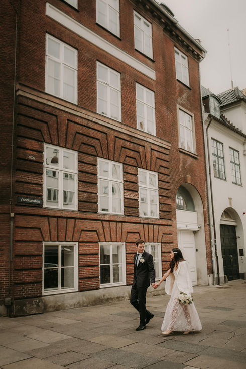 Bridge and groom strolling through Copenhagen