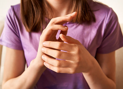 Young teenage girl practicing EFT or emotional freedom technique at home - tapping on the