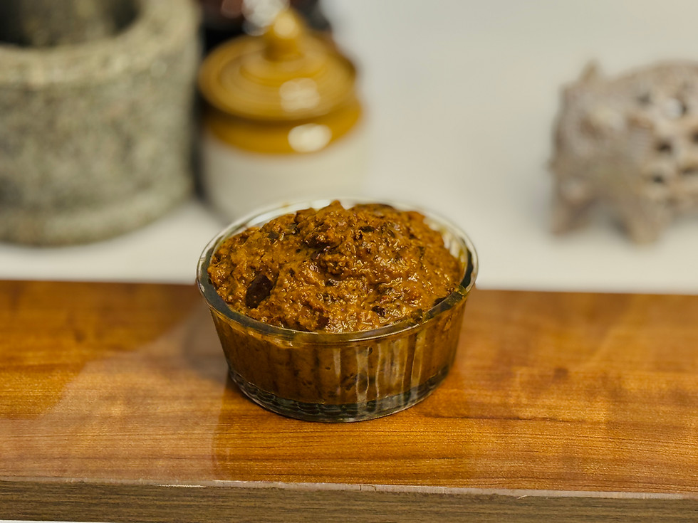 The coarse, rustic green-brown texture of traditional Chintakaya pickle.