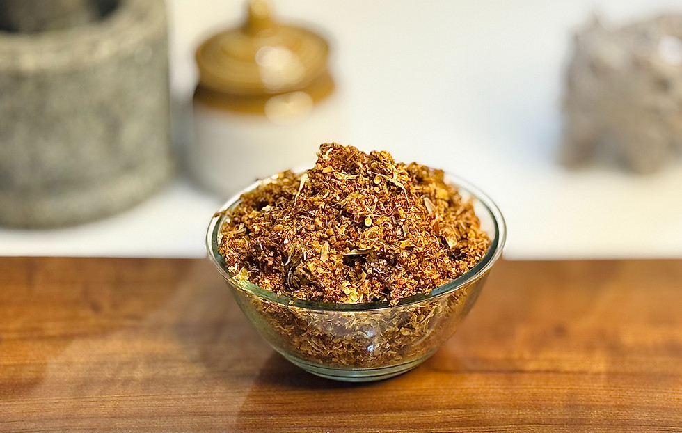A coarse, reddish-brown Vellulli Karam Podi with visible garlic pieces.