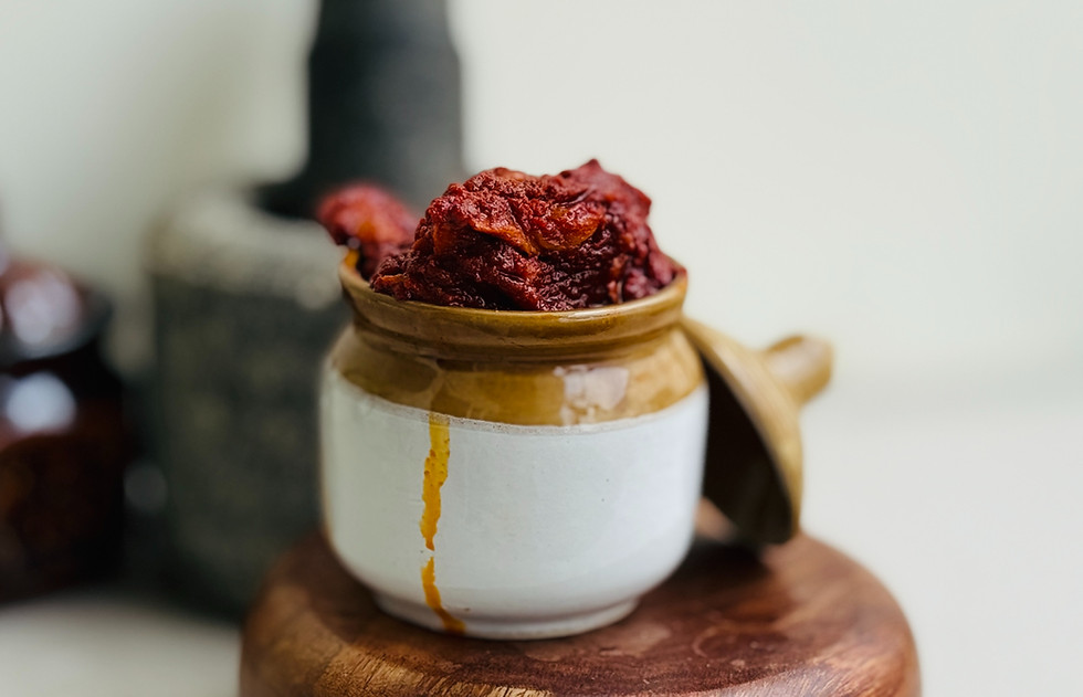 Chewy, sun-drenched mango slices glistening in the red oil of Magaya pickle.