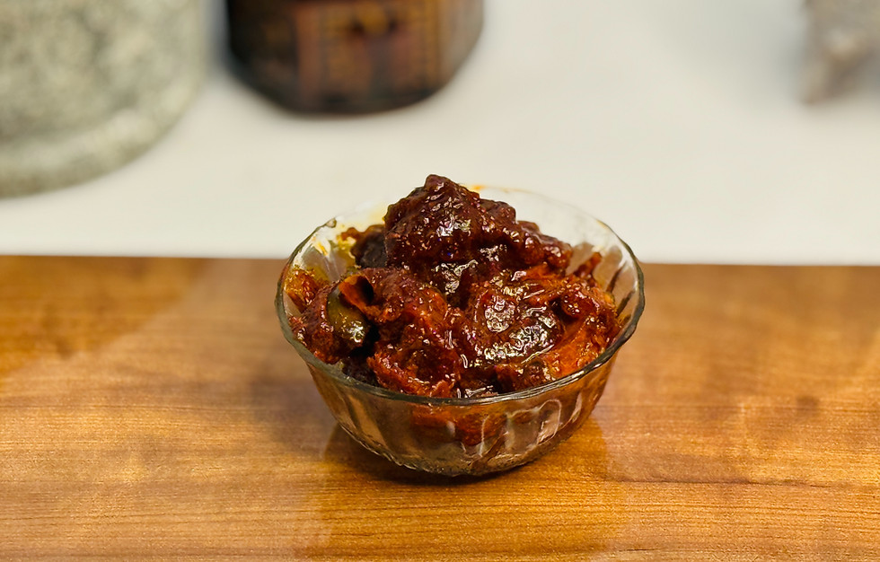A bowl of dark, glistening Bellam Avakaya (Jaggery Mango Pickle).