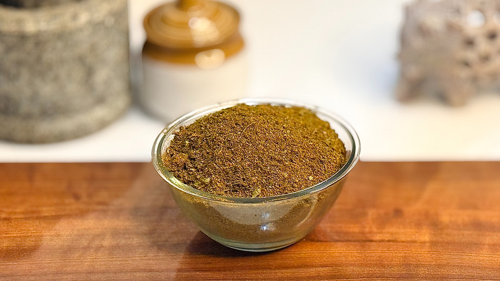 A dark green, fragrant Karvepaku Podi (Curry Leaf Powder) in a small bowl.