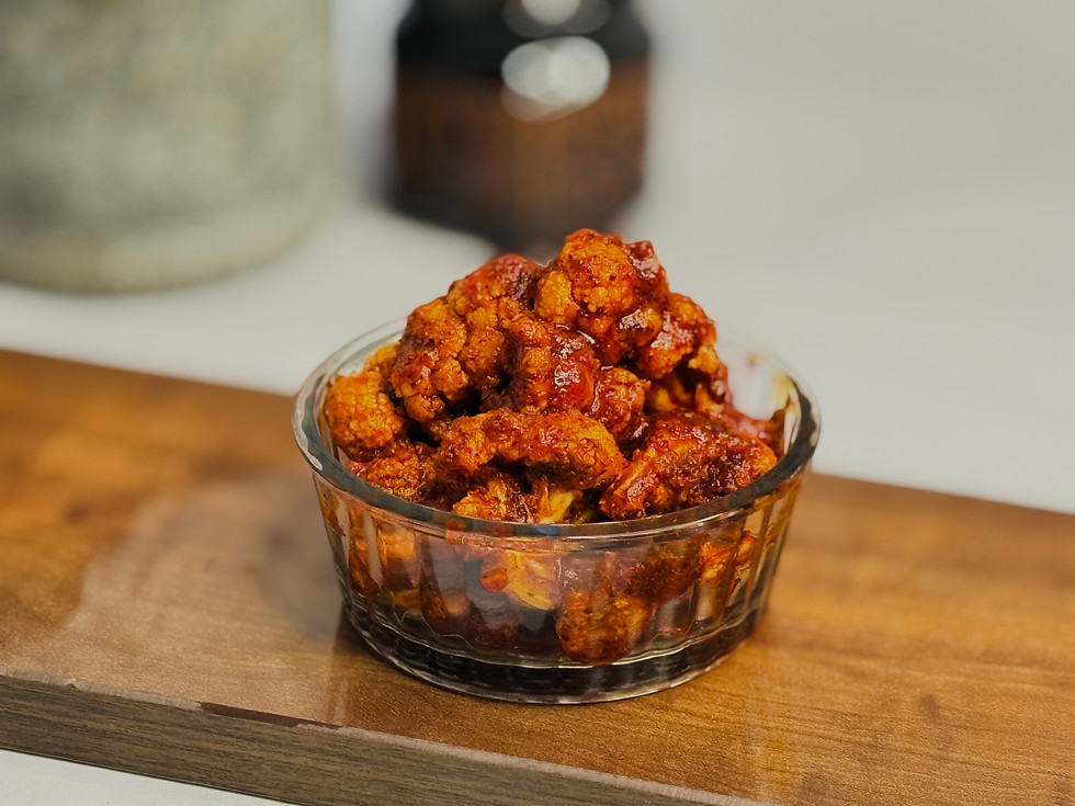 Jar of Cauliflower (Gobi) Avakaya with visible florets in a rich red masala.