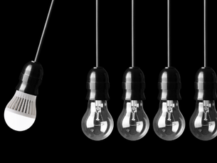 Newtons cradle style image of lightbulbs illustrating impact