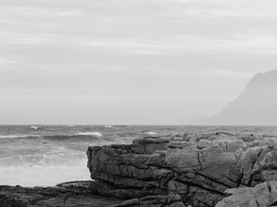 Business man standing on a rocky promontory considering the future of his business... why company vision statements don't work for SMEs