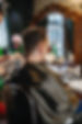Barber cutting man's hair with clippers