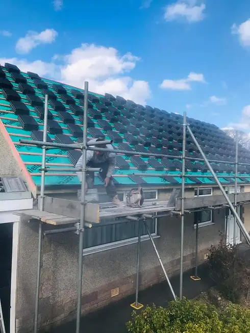 Roofer working on a slate roof