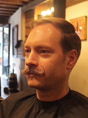 Man with moustache and comb over