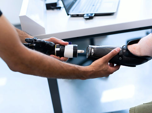 A prosthetic arm attached to a man is being assembled