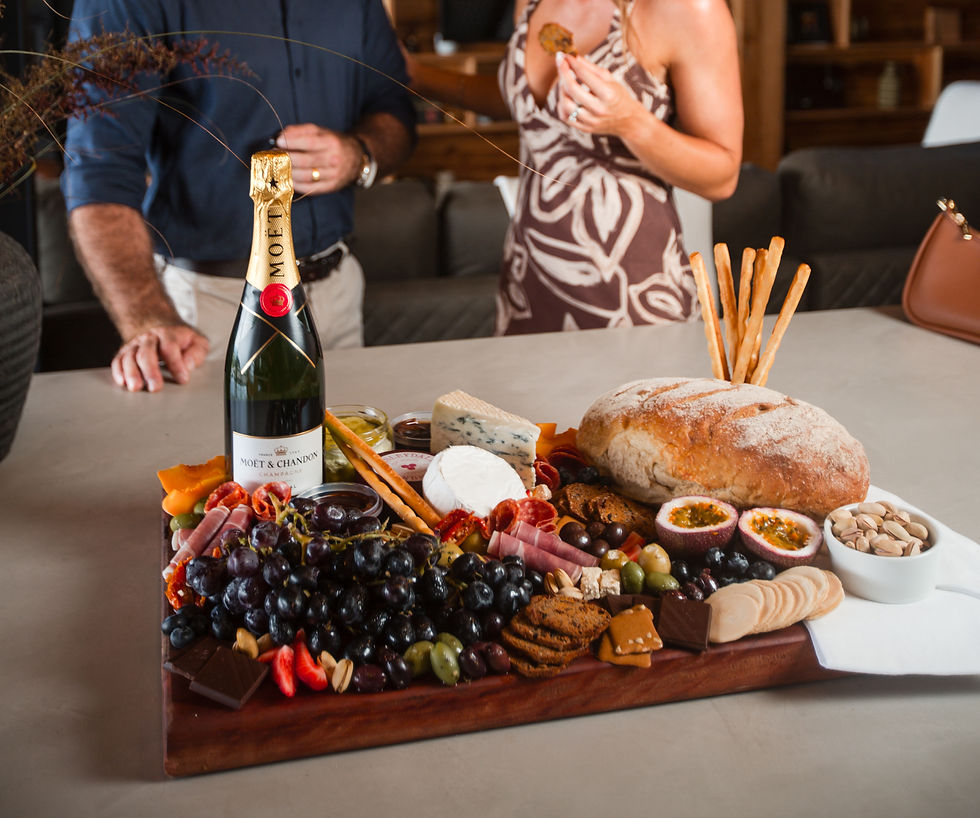 A lavish arrival platter with champagne, cheeses, fruits.