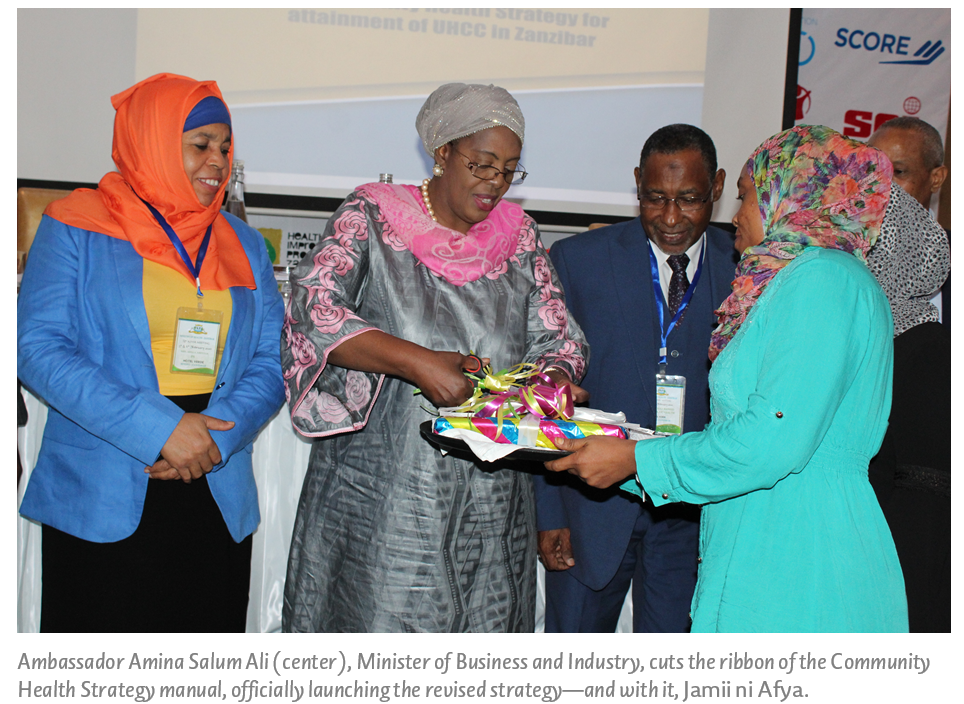Ambassador Amina Salum Ali (center), Minister of Business and Industry, cuts the ribbon of the Community Health Strategy manual, officially launching the revised strategy—and with it, Jamii ni Afya.