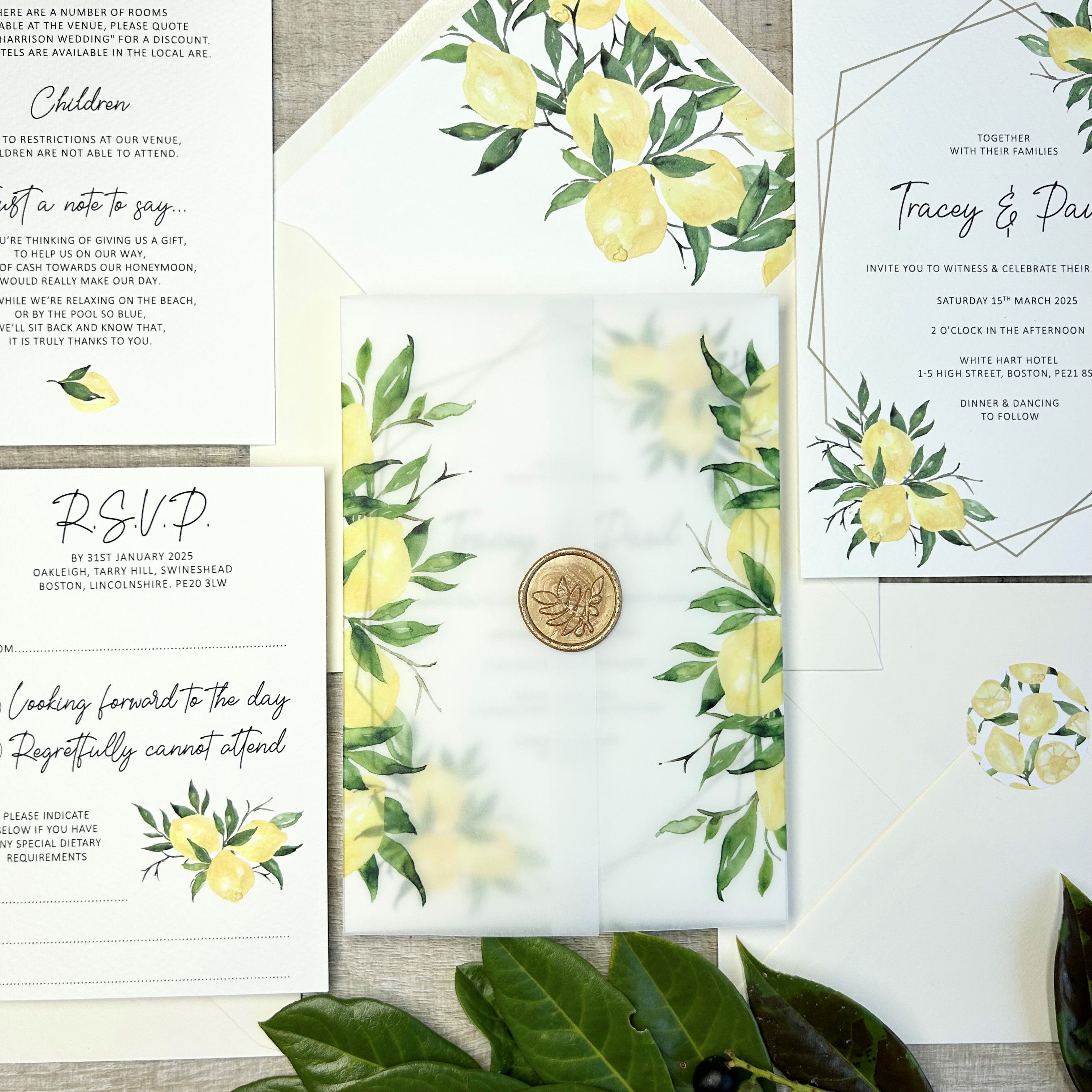 Wedding invitation with a vellum wrap printed with bright yellow lemons finished with a gold wax seal
