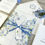 Thumbnail: Forget me not invitation wrapped with vellum jacket finished with a quality satin ribbon and tag