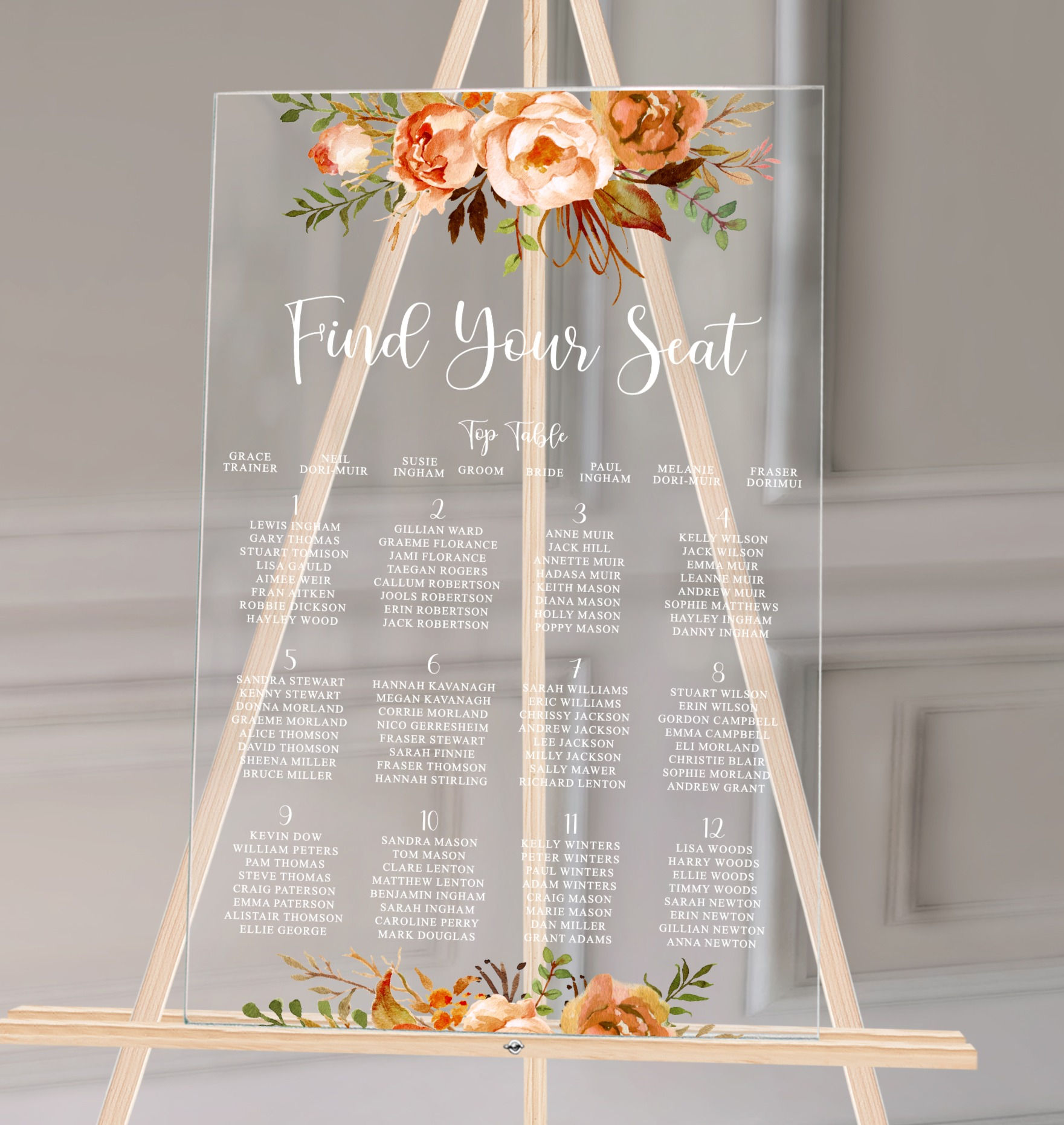 A clear acrylic wedding table plan Burnt orange florals