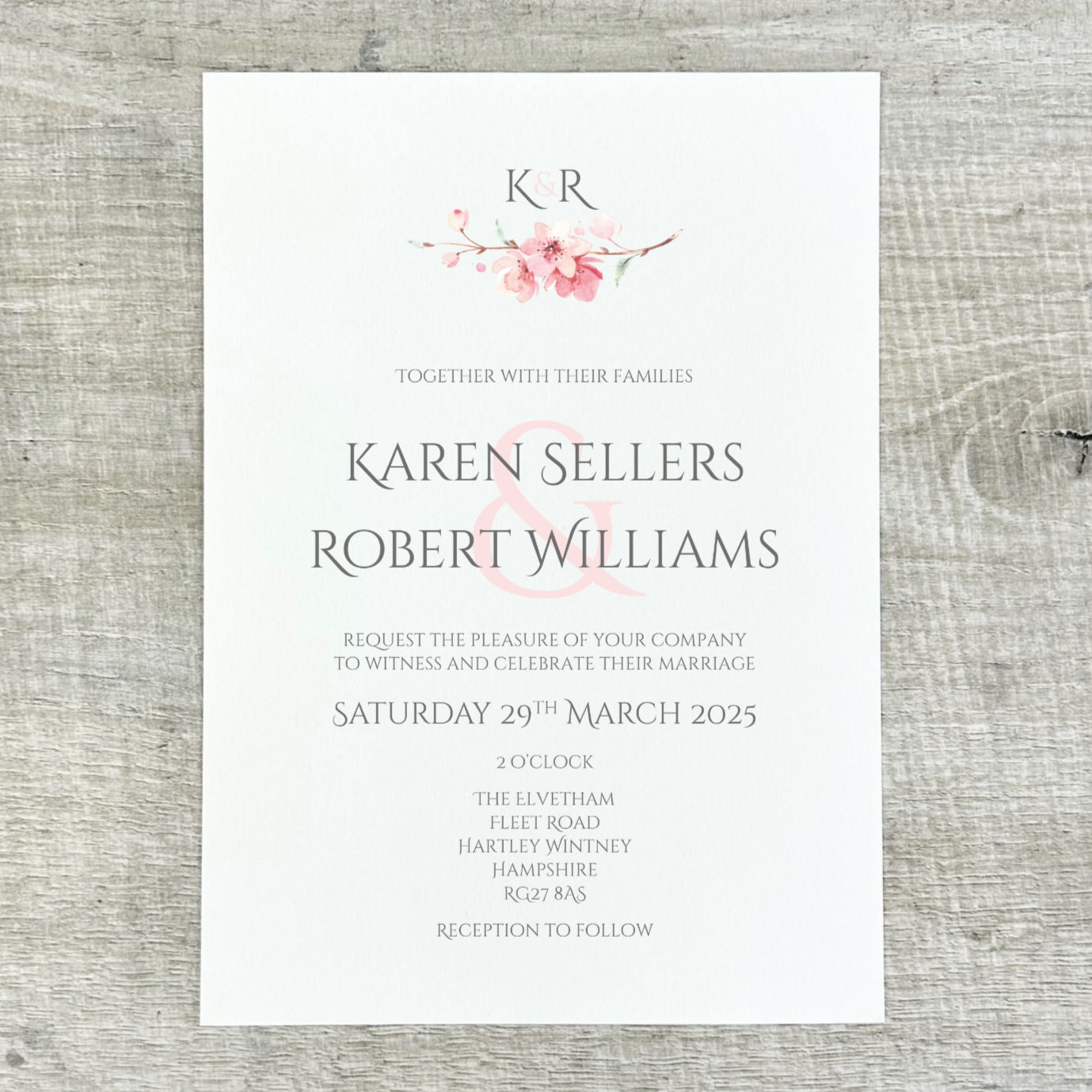 Flat wedding invitation with a printed pink cherry blossom design
