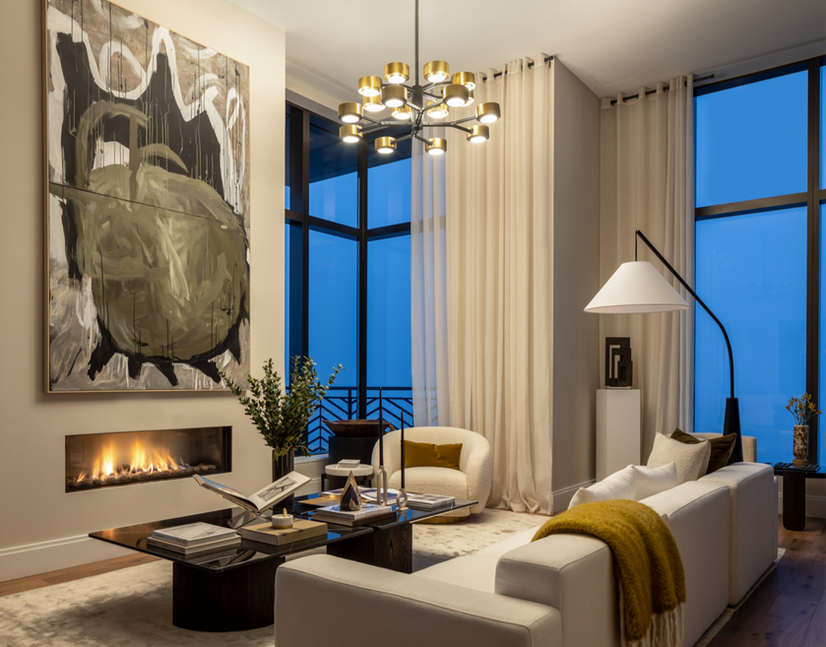 <img src=”modern- living room -New York City.jpg” alt=”Modern living room with a minimalist fireplace, large abstract artwork, and floor-to-ceiling windows, featuring a white sofa, glass coffee table, and warm ambient lighting.”/>