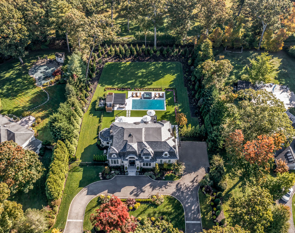 <img src=”Luxurious-contemporary-house-Old Westbury.jpg” alt=”aerial view of large contemporary home on estate with landscaped grounds & fall colors in Old Westbury”/>