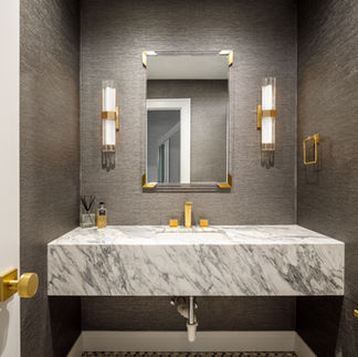 <img src=”elegant-contemporary-bathroom-Hewlett.jpg” alt=”contemporary bathroom with white and gold marble counter  and gold finishes”/>