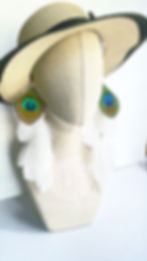 white feather earrings with peacock