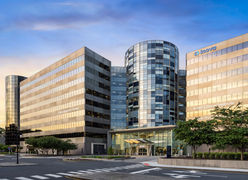 Exterior of Inova hospital campus with glass entry and branded signage