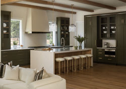 Transitional kitchen with olive cabinets, island seating, and pendant lights