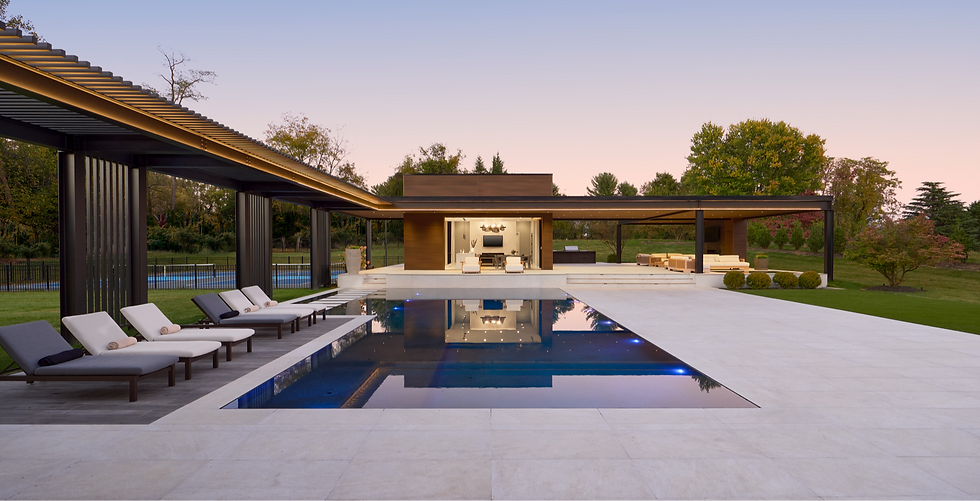 Lakeside pool deck with lounge chairs, hot tub, and fire pit seating