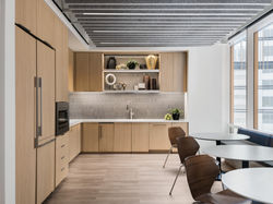 Contemporary office kitchen with wood cabinetry and dining space