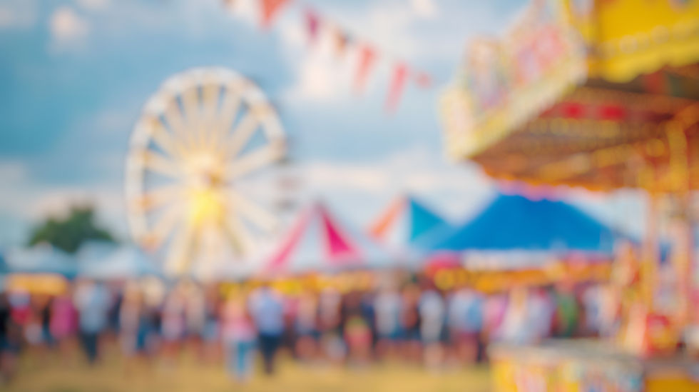 Blur Background of Colorful Carnival Scene with Ferris Wheel and Vintage Carousel in a Fes