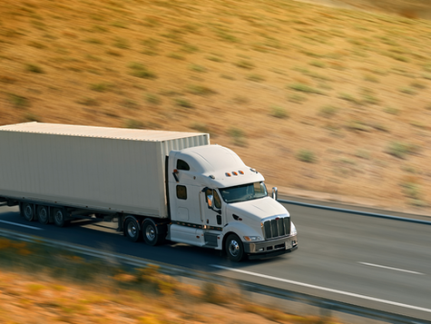 truck driving in plains on the road